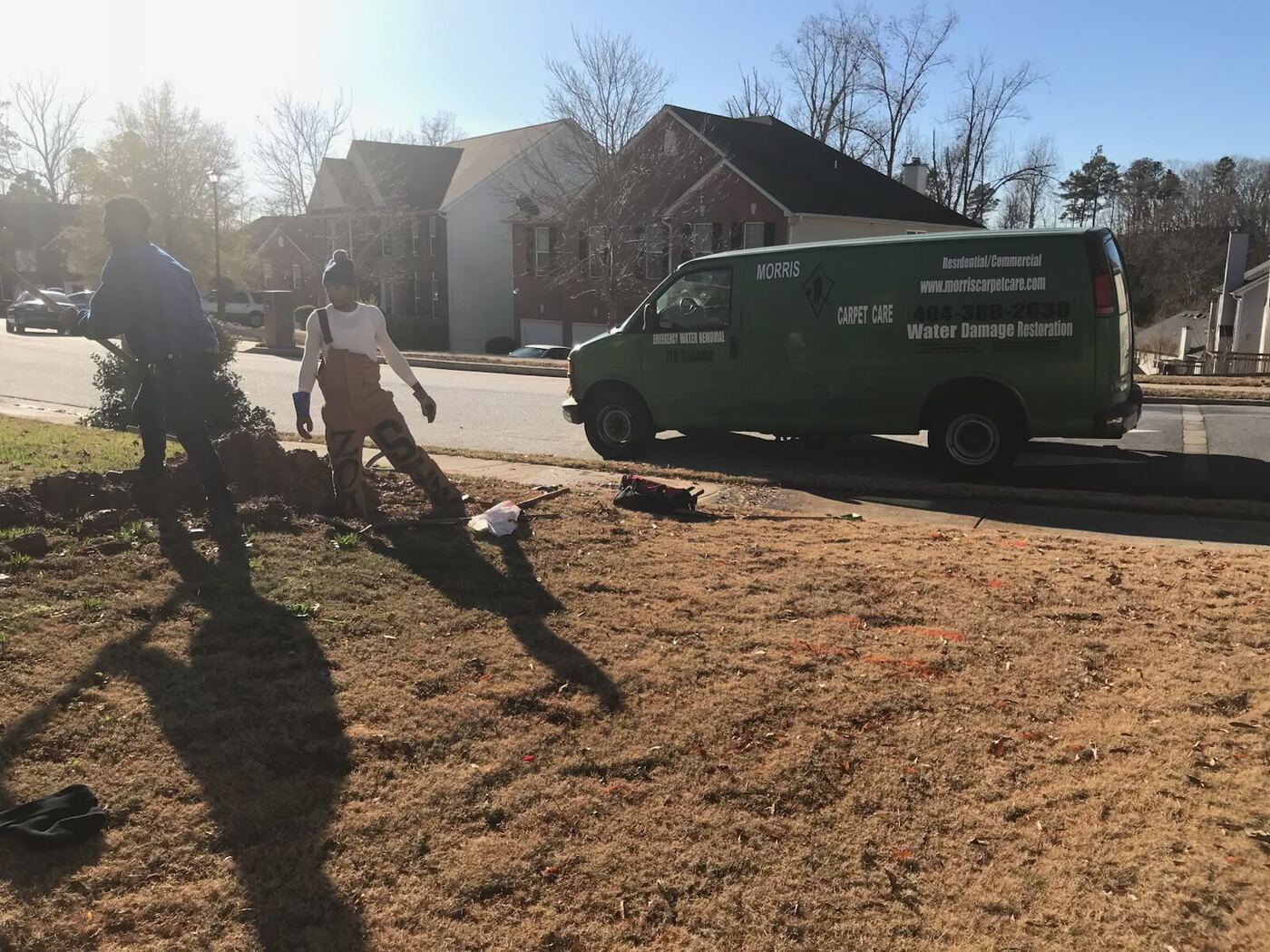 Morris Plumbing crew and service truck at a neighborhood water line repair