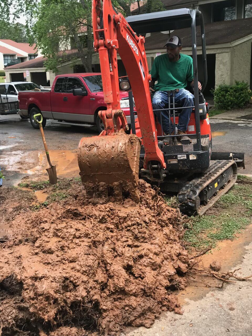 Morris Plumbing excavator digging a water line trench at an Atlanta home